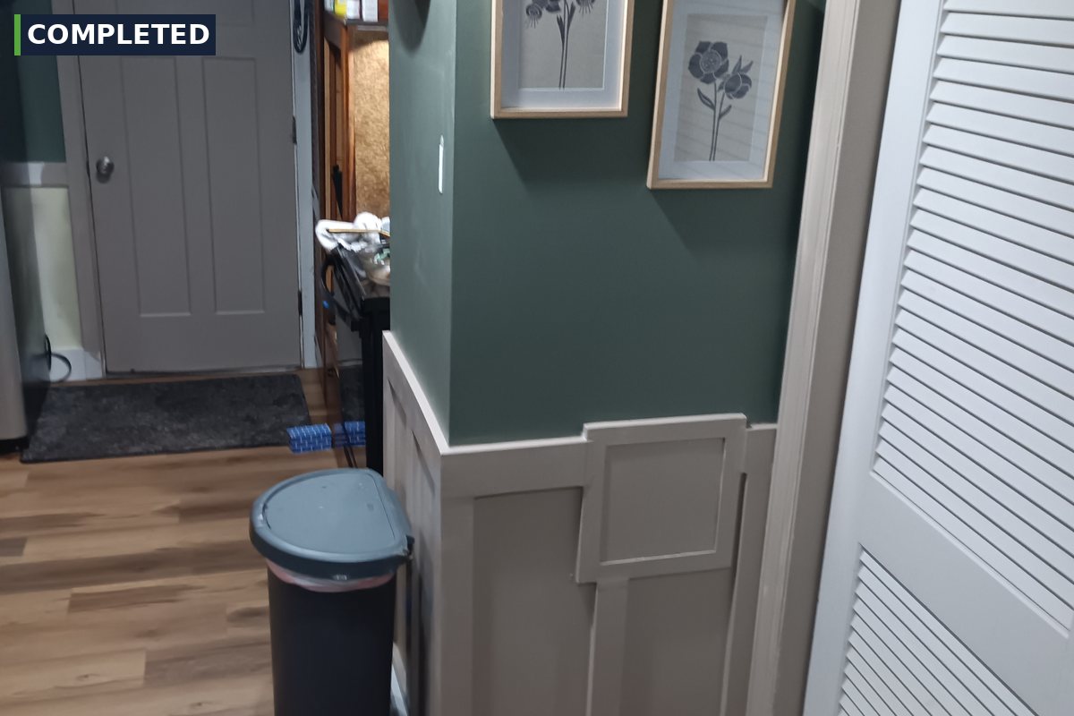 Green accent wall with board and batten wainscoting